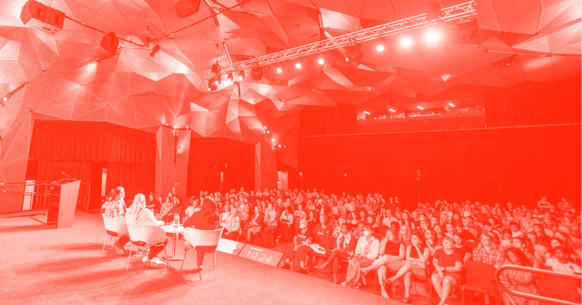 Photo of panellists on stage in the Great Hall for IWD 2023